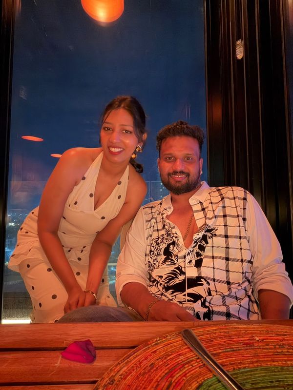 At a rooftop table at night.